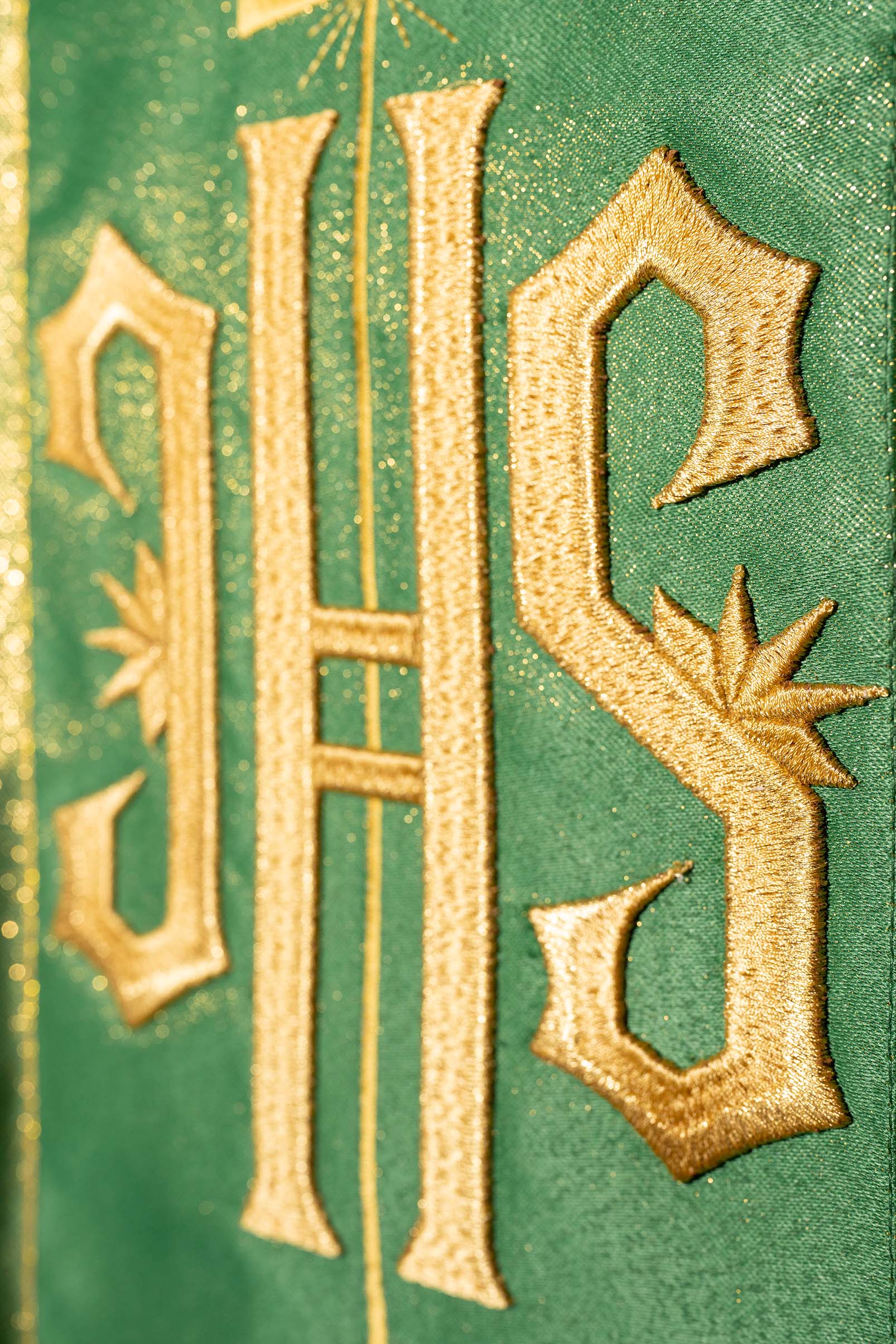 Chasuble vert richement décoré avec un motif doré et une large bande brodée IHS