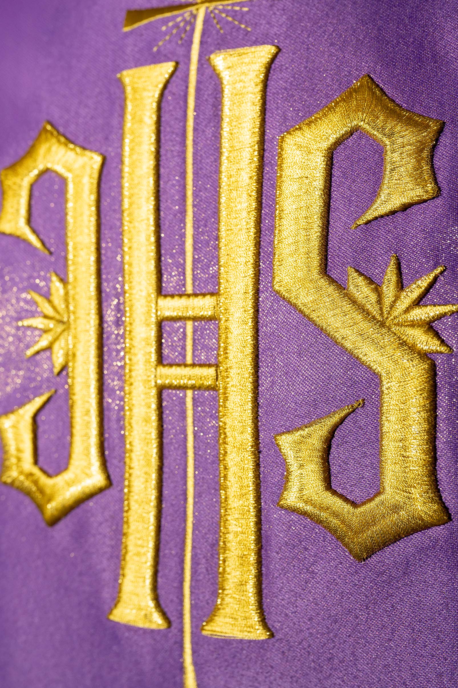 Chasuble violet richement décoré avec un motif doré et une large bande IHS