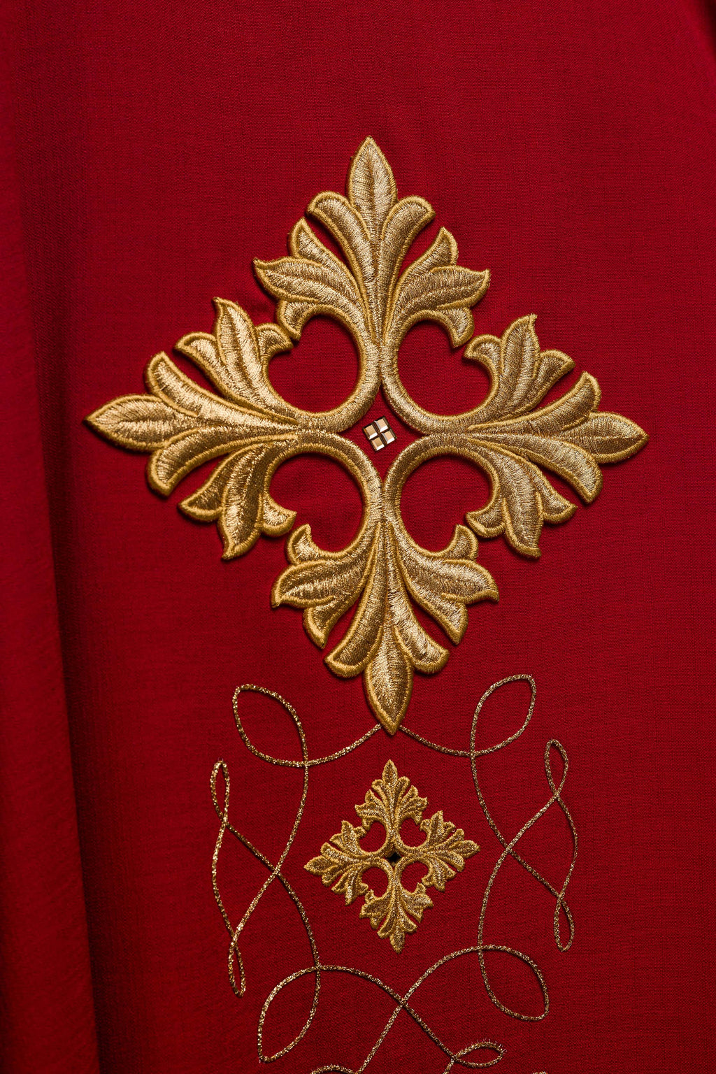 Chasuble rouge richement brodée de cordes et de pierres