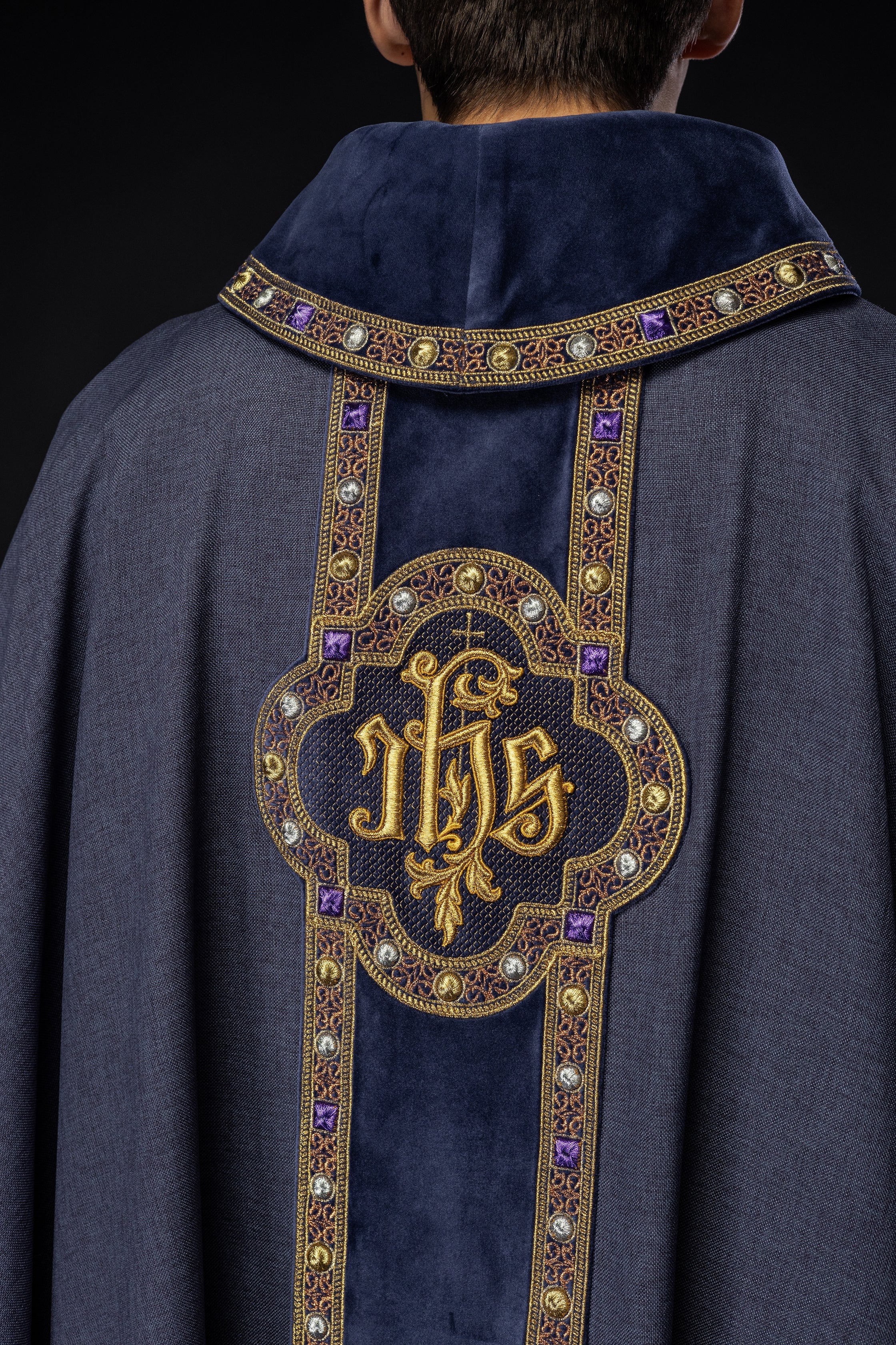 Chasuble avec une ceinture et un galon richement brodés autour de la broderie IHS et un col violet