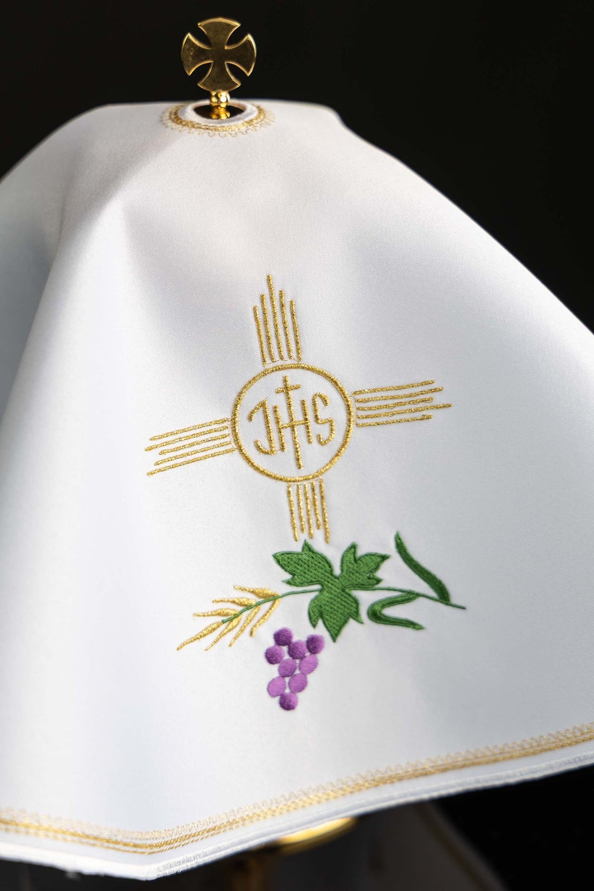 Voile de ciboire rond blanc, gros plan sur la broderie IHS et le motif eucharistique